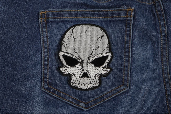 Small Cracked Skull Patch Grey shown on jeans