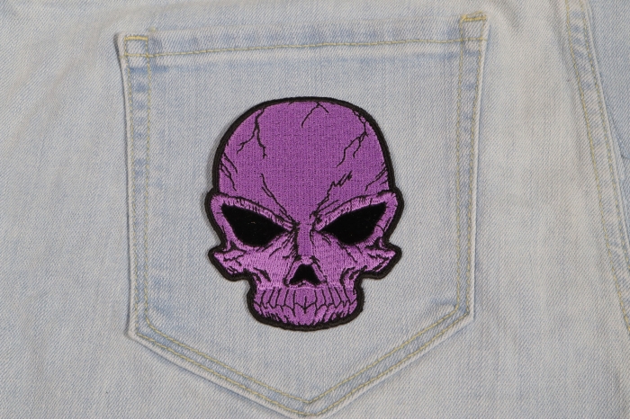 Small Cracked Skull Patch Purple shown on jeans