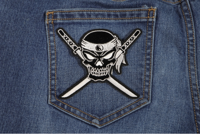 Small Skull Cross Swords Patch shown on jeans