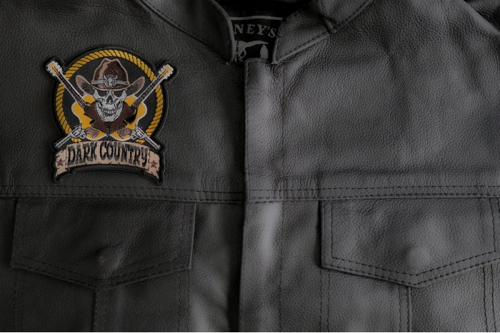 Dark Country Music Patch with Skull Cowboy Hat Guitars Pistols  shown on leather vest