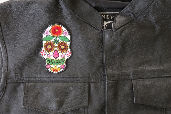 Flower Skull White Patch - 2.6x4 inch. Embroidered Iron on Patch shown on leather vest