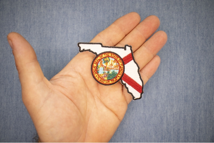 Florida Patch with State Seal and Map shown on hand for size comparison