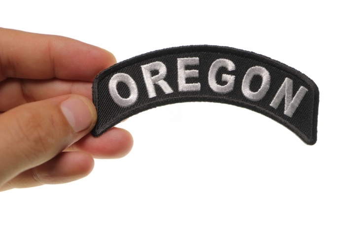 Oregon Patch Iron on State Rocker shown on hand for size comparison