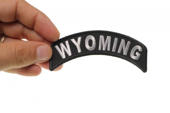 Wyoming Patch Iron on State Rocker shown on hand for size comparison