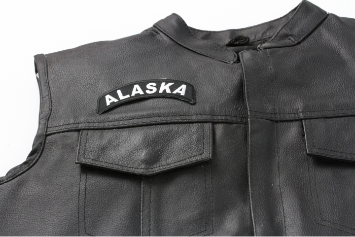Alaska Patch - 4x1.75 inch. Embroidered Iron on Patch shown on leather vest