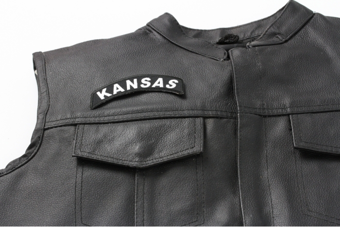 Kansas Patch - 4x1.75 inch. Embroidered Iron on Patch shown on leather vest