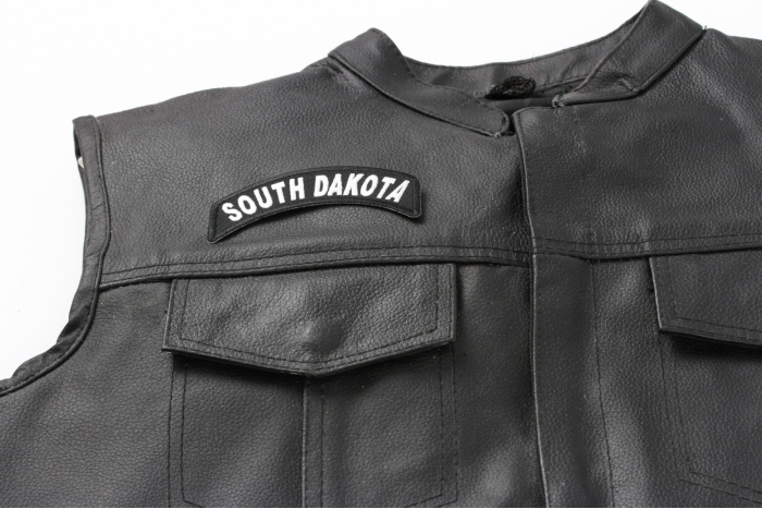South Dakota Patch - 4x1.75 inch. Embroidered Iron on Patch shown on leather vest