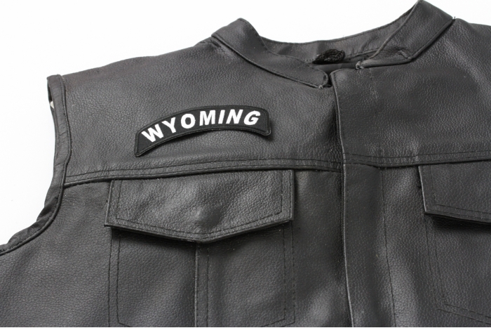 Wyoming Patch - 4x1.75 inch. Embroidered Iron on Patch shown on leather vest