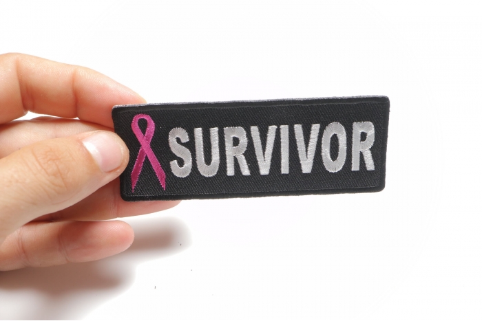 Breast Cancer Survivor Pink Ribbon Patch shown on hand for size comparison