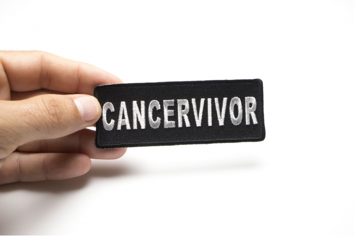 Cancervivor Patch shown on hand for size comparison