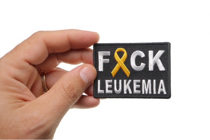 FCK Leukemia Orange Ribbon Patch shown on hand for size comparison
