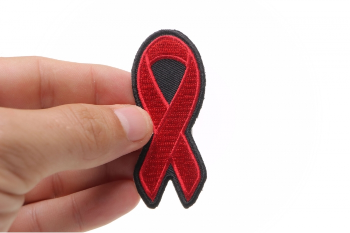 Red Ribbon Aids Awareness Patch shown on hand for size comparison