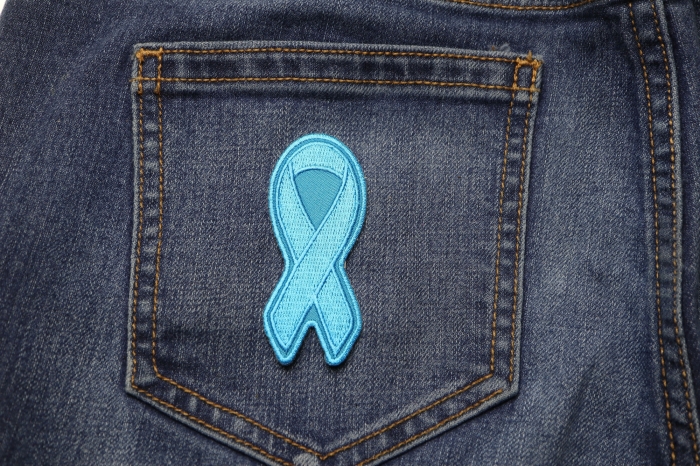 Blue Ribbon Patch For Awareness In Child Abuse and Bullying shown on jeans