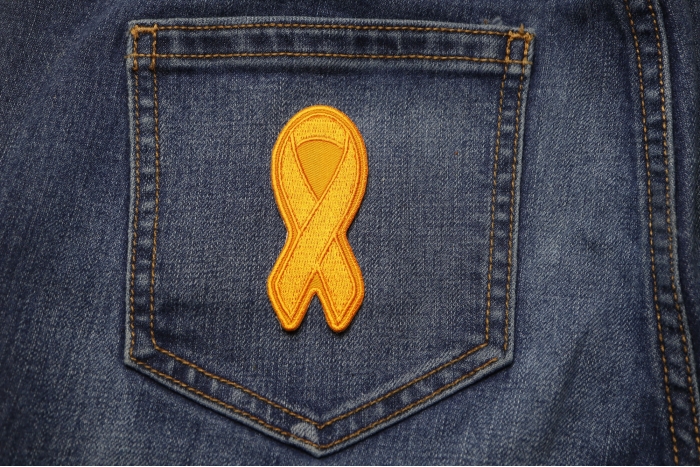 Orange Leukemia Awareness Ribbon Patch shown on jeans