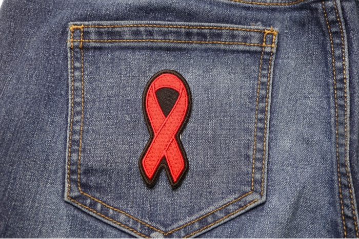 Red Ribbon Aids Awareness Patch shown on jeans