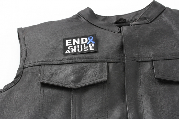 End Child Abuse Blue Ribbon Patch - 2.75x2 inch. Embroidered Iron on Patch shown on leather vest