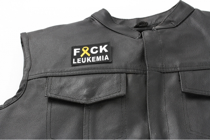 FCK Leukemia Orange Ribbon Patch - 2.75x2 inch. Embroidered Iron on Patch shown on leather vest