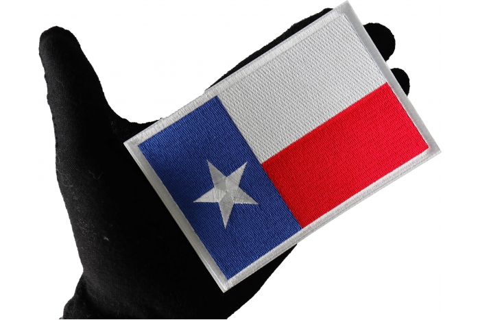 Texas Flag Sew on Patch for Vests shown on hand for size comparison
