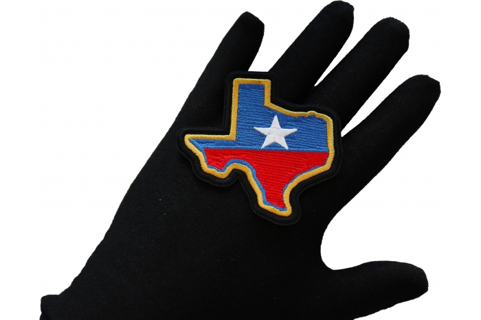 Texas Patch shown on hand for size comparison
