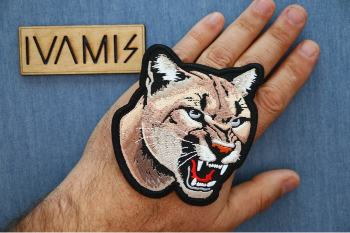 Cougar Patch shown on hand for size comparison