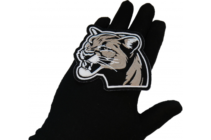 Cougar Patch shown on hand for size comparison