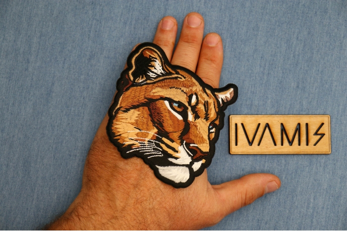 Mountain Lion Patch shown on hand for size comparison