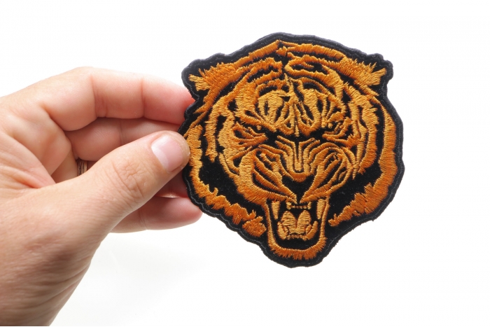 Small Orange Baron Tiger Iron on Patch shown on hand for size comparison