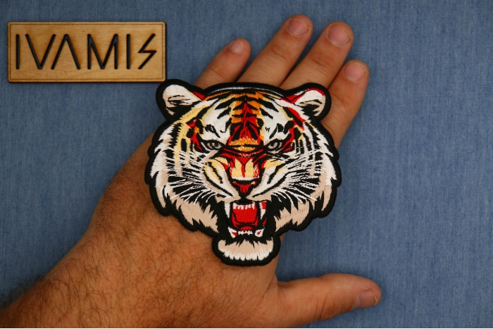 Tiger Snaring Patch shown on hand for size comparison