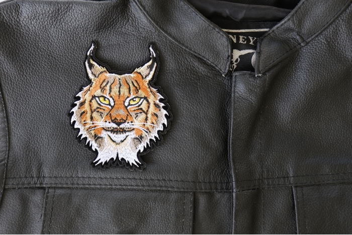 Lynx Cat Small Patch - 3.6x4.5 inch - Embroidered Iron on Patch shown on leather vest