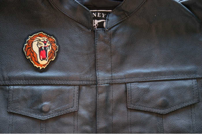 Male Lion Iron on Patch shown on leather vest