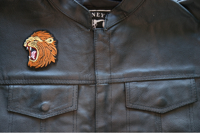 Screaming Lion Iron on Patch shown on leather vest