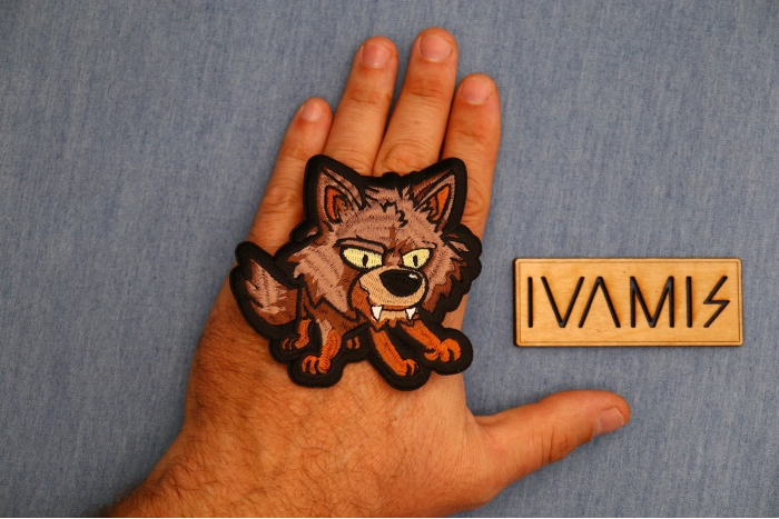 Baby Cartoon Wolf Patch shown on hand for size comparison