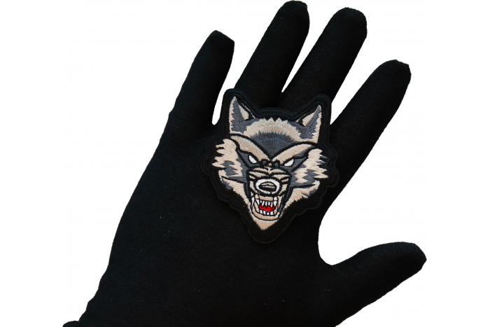 Mean Wolf Iron on Patch shown on hand for size comparison
