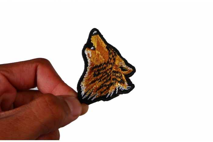 Mini Wolf Head Iron on Patch shown on hand for size comparison