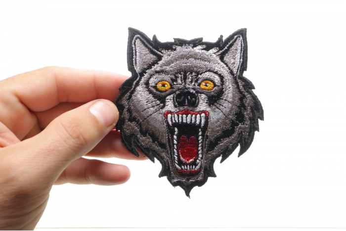 Small Wolf Iron on Patch shown on hand for size comparison