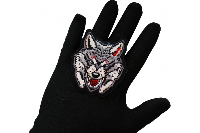 Snarling Wolf Iron on Patch shown on hand for size comparison
