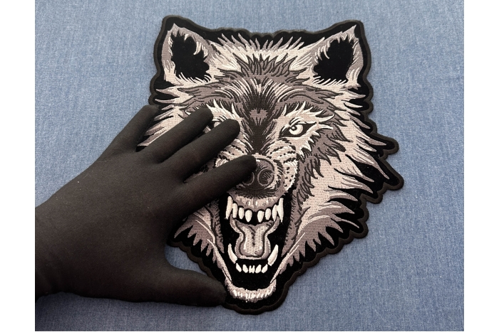 Wolf Patch, Large Animal Patches for Jackets shown on hand for size comparison