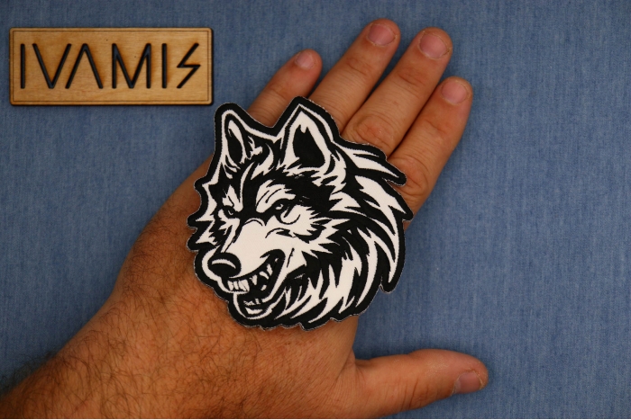 Tribal Wolf Decal Patch shown on hand for size comparison