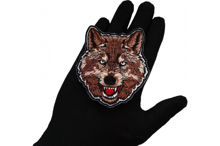 Wolf Patch shown on hand for size comparison
