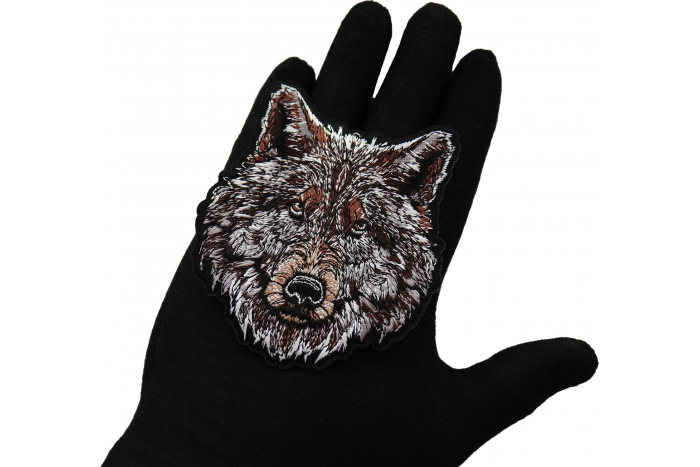 Wolf Patch shown on hand for size comparison