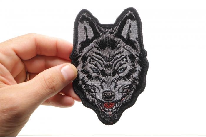 Wolf Sew on Patch for Vests shown on hand for size comparison