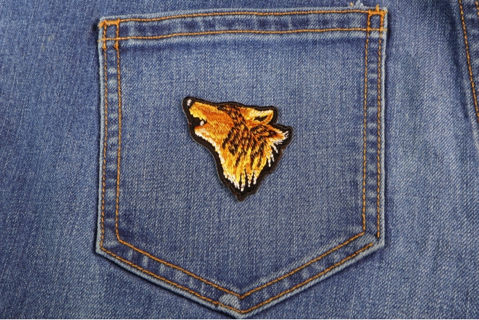 Mini Wolf Head Iron on Patch shown on jeans