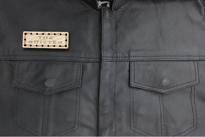 The Shitter Oak Wood Patch shown on leather vest
