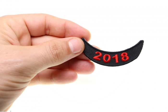 2018 Lower Rocker Red Patch shown on hand for size comparison