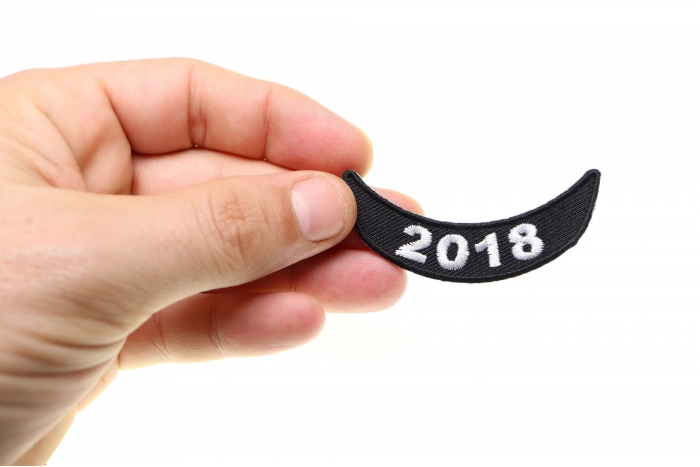 2018 Lower Rocker White Patch shown on hand for size comparison