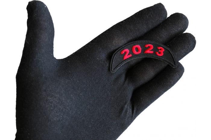 2023 Year Patch Upper Rocker Red shown on hand for size comparison