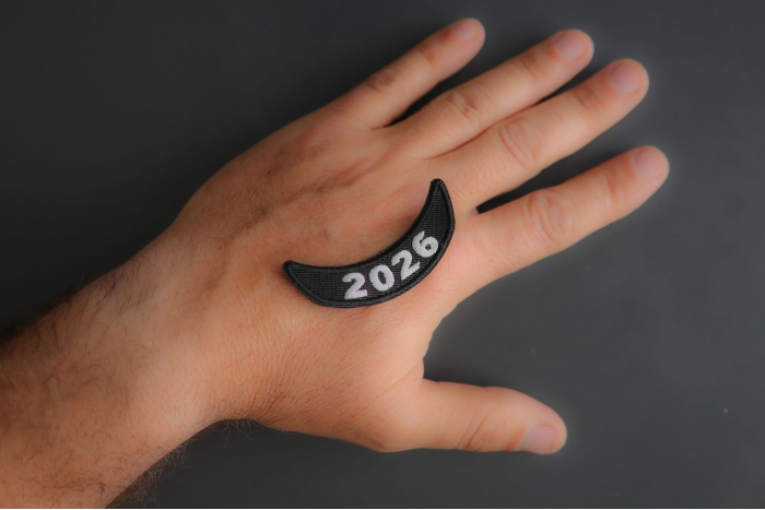 2026 Lower Rocker White Year Patch shown on hand for size comparison