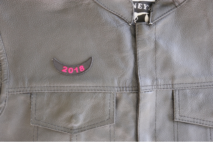 2018 Lower Rocker Red Patch - 2.5x1 inch. Embroidered Iron on Patch shown on leather vest