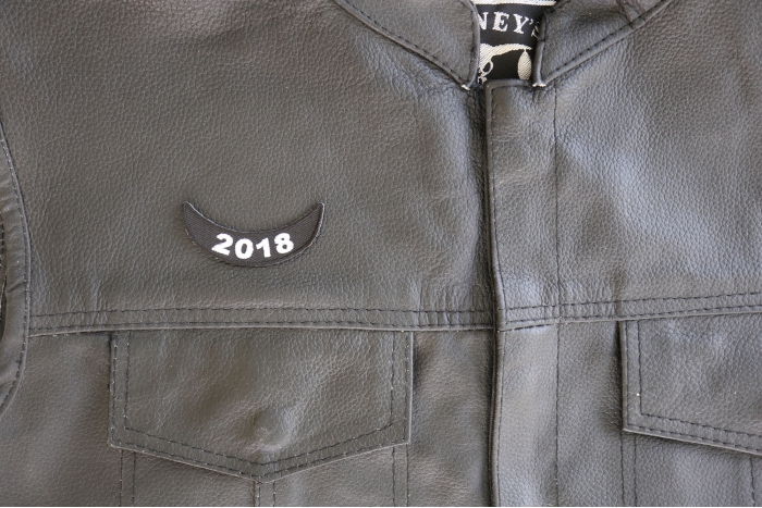 2018 Lower Rocker White Patch - 2.5x1 inch. Embroidered Iron on Patch shown on leather vest