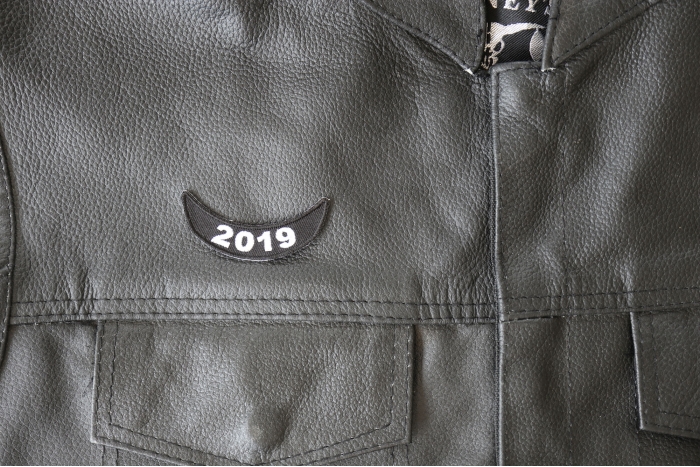 2019 Lower Rocker Patch - 2.5x1 inch - Embroidered Iron on Patch shown on leather vest